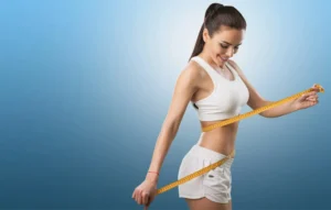Women measuring her waist after Medical Weight Loss at Rejuven8 Medical