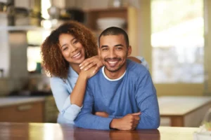 Happy couple smiling after learning about sexual wellness treatments that improve confidence and comfort
